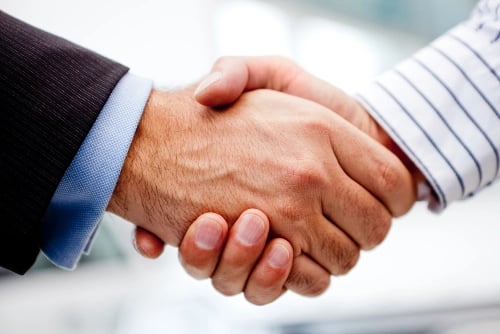 Business handshake of two men closing a deal