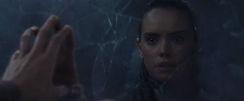 Rey is in the Ahch-To Pit looking at a broken mirror.