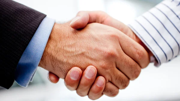 Business handshake of two men closing a deal-2
