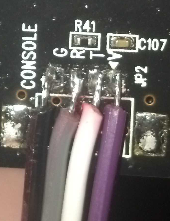 Jumper wires soldered to the UART pins on the PCB for easier interfacing
