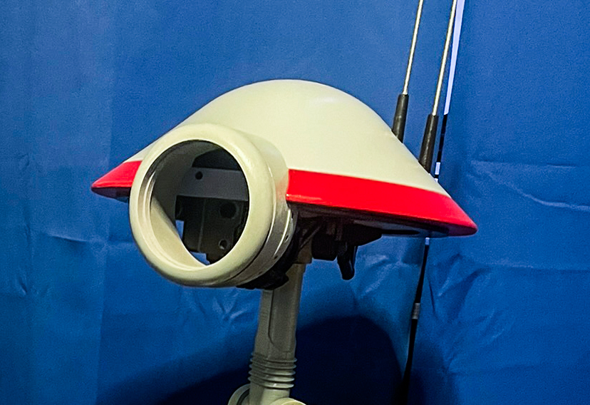 The circular eye opening of the Pit Droid before the camera mount