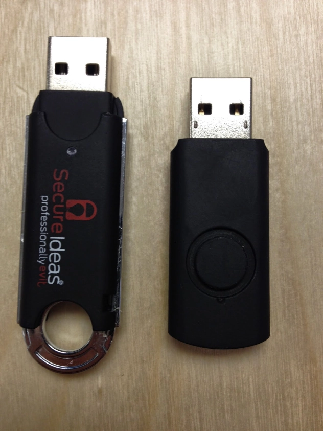 Two USB devices side by side showing a Secure Ideas branded thumb drive on the left and a rubber ducky HID device on the right